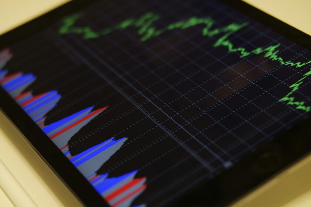 Investing Close-up of a tablet displaying stock market analysis with colorful graphs.