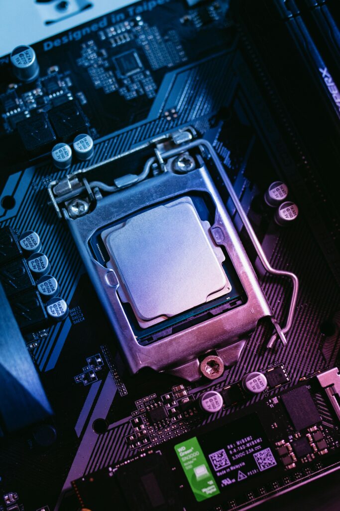 Laptop Detailed close-up of a computer motherboard highlighting the CPU socket with electronic components.