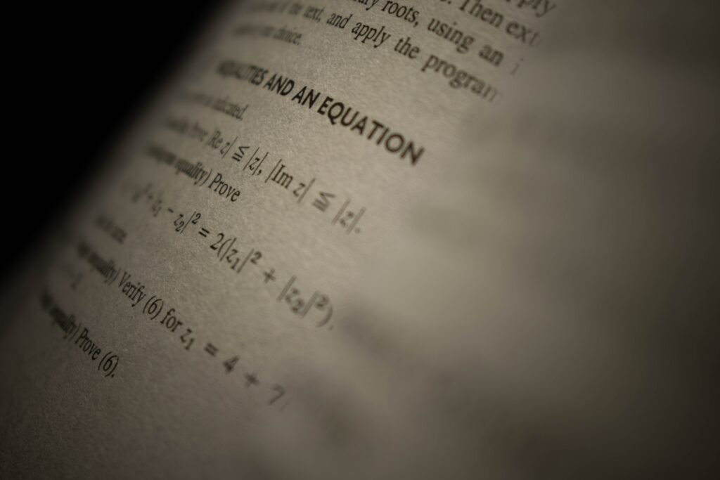 Investing Selective focus on a mathematics textbook page with complex equations and text.