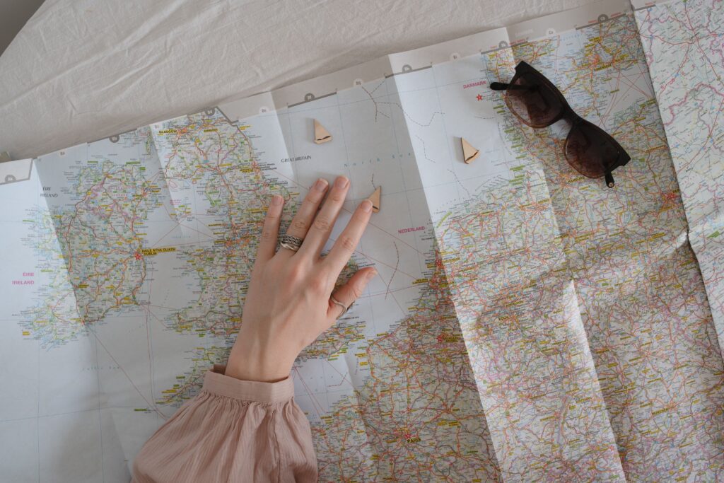 Interior design A hand exploring a map with sunglasses for travel planning.
